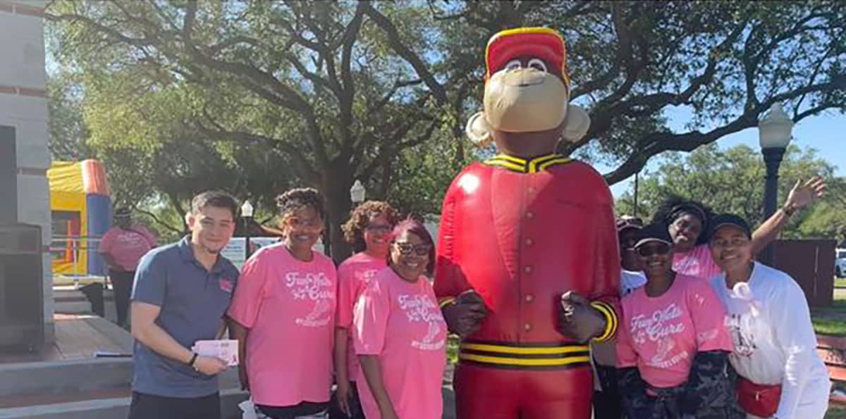 This converted Grease Monkey store supports many causes, and a group posed for photos with the Grease Monkey mascot at the fundraising event shown above.