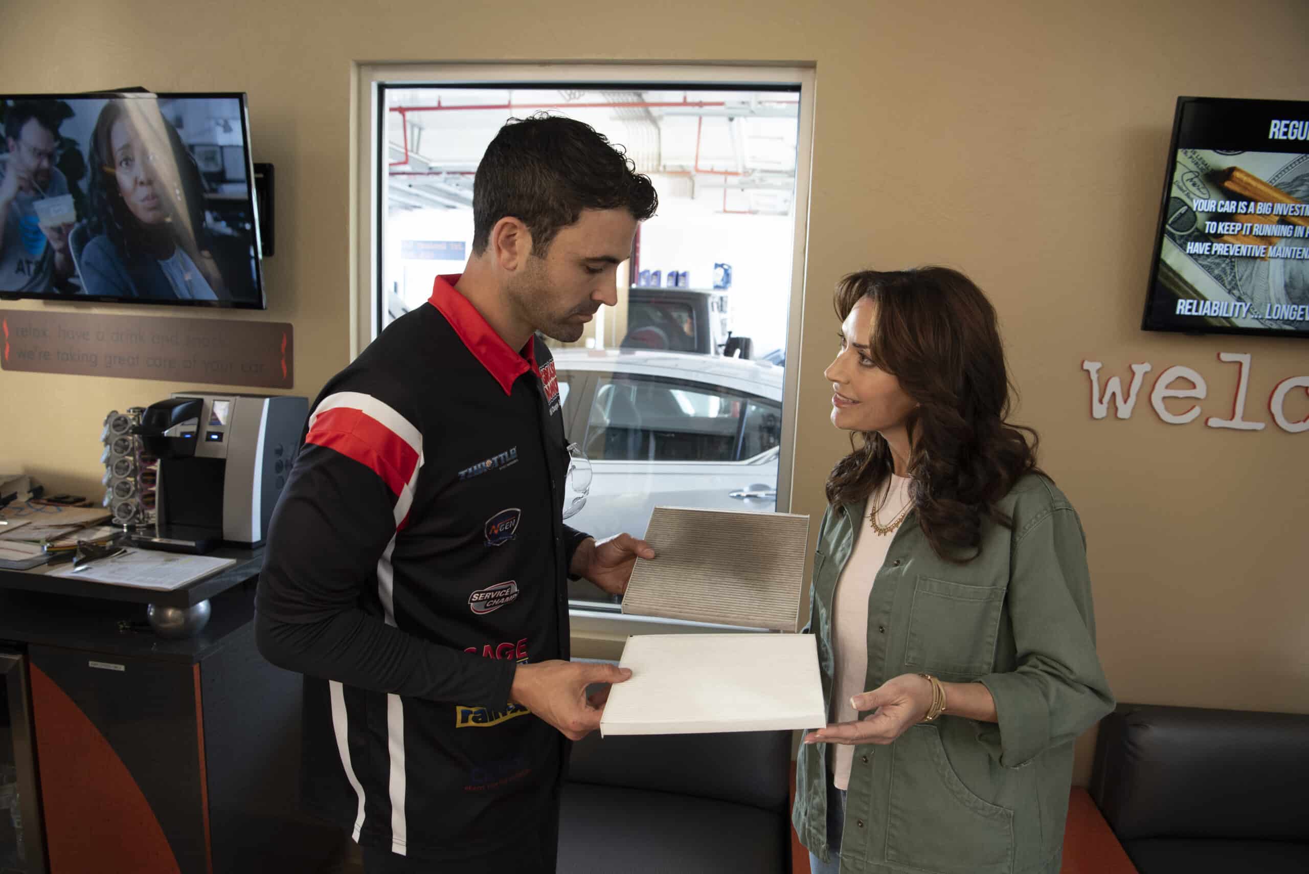 Technician goes over paperwork with a female customer.